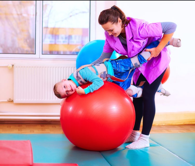 Rehabilitation through play - a boy undergoing playful rehabilitation with his physio