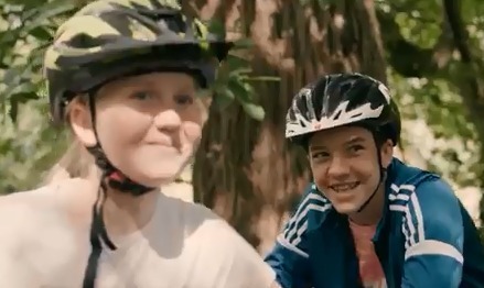 Smiling children with cycle helmets ahead of call for compulsory wear