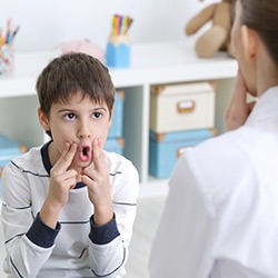 A child undergoing speech and language therapy with a therapist