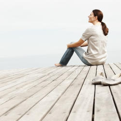 A woman stares longingly out to see emphasising the impact a brain injury can have on secondary victims