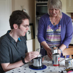 A man with an acquired brain injury making coffee as part of breakfast illustrating the role of nutrition to people who have brain injuries