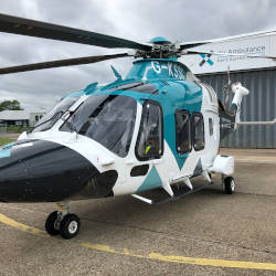 A helicopter from the Kent, Surrey and Sussex Air Ambulance illustrating paying it forward to emergency air ambulance through a personal injury claim.