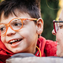 A smiling brain injured child and his mother illustrating bringing a brain injury claim for a child