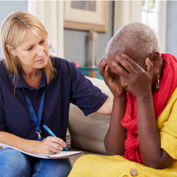 A healthcare practitioner comforts a lady during a mental capacity assessment illustrating fluctuating capacity