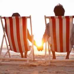 A photo of a couple in deck chairs on the beach as the sun sets illustrating regaining capacity and the implications to deputies