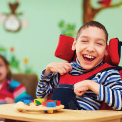A child playing in a high-chair illustrating the case study of Child F and non-accidental criminal injuries