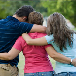 Family members cuddle each other illustrating secondary victims