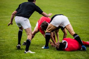 Rugby tackle featuring male players